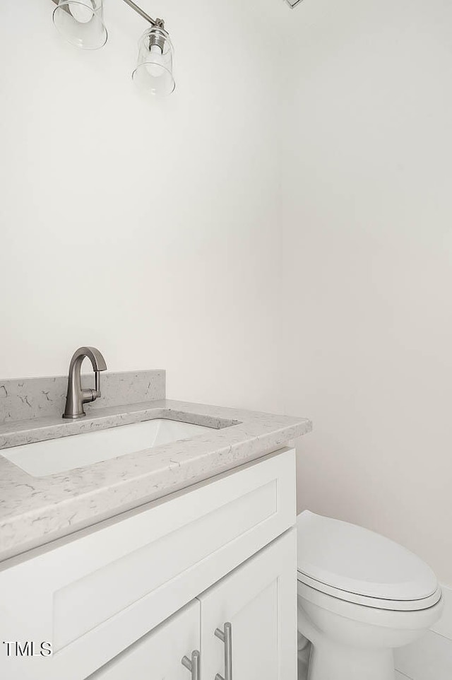 bathroom with vanity, toilet, and tile patterned flooring