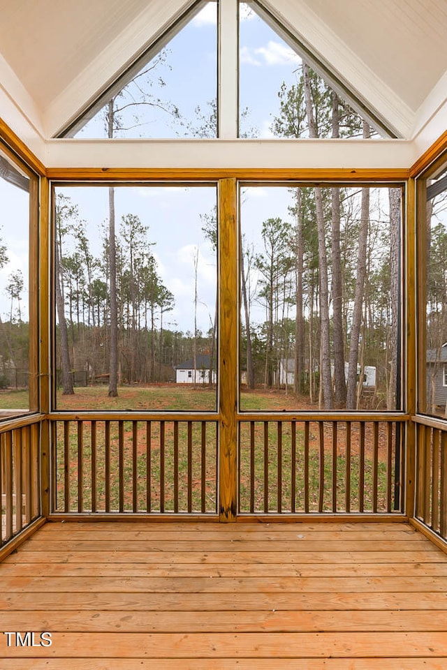 unfurnished sunroom featuring a wealth of natural light and vaulted ceiling