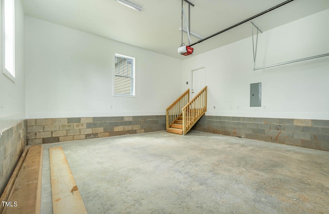 garage featuring electric panel and a garage door opener