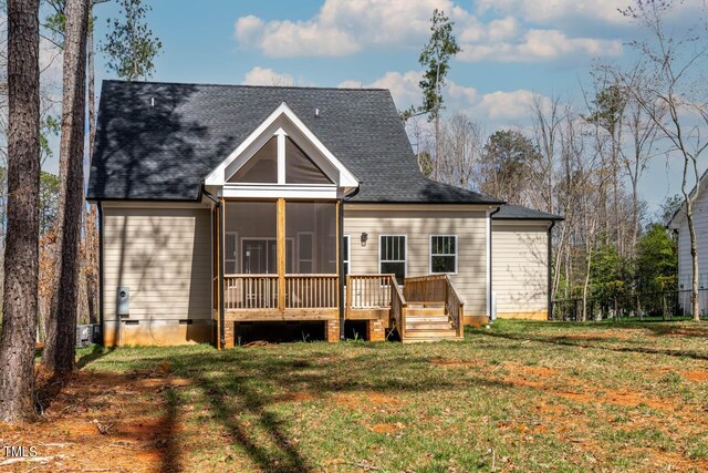 back of property featuring a lawn, a wooden deck, and a sunroom