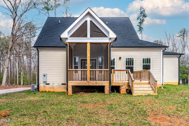 back of house with a yard, a sunroom, and central air condition unit