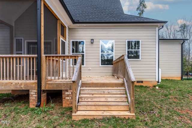 rear view of property with a wooden deck and a sunroom