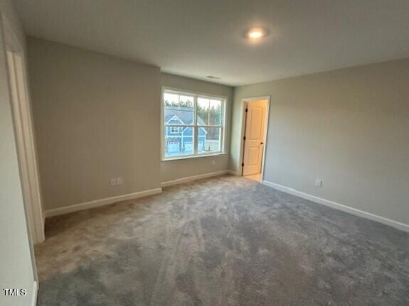 unfurnished bedroom with carpet floors and baseboards