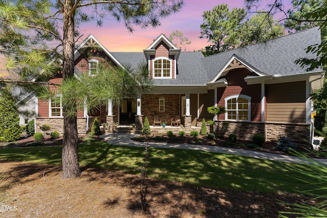 craftsman-style house with a yard