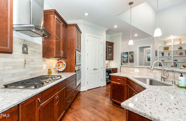 kitchen with decorative light fixtures, appliances with stainless steel finishes, sink, wall chimney range hood, and dark hardwood / wood-style floors