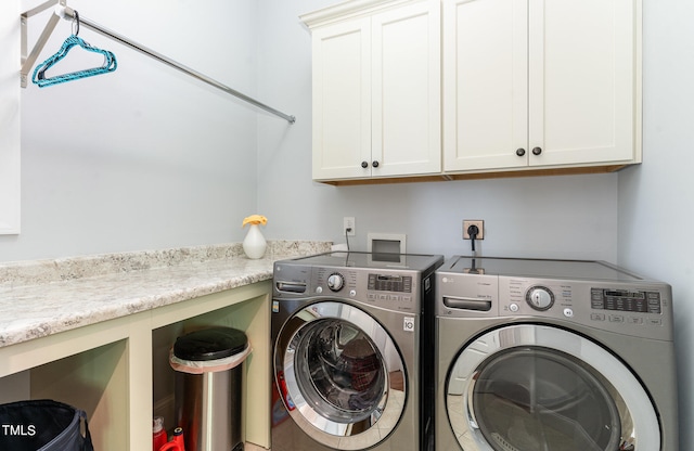 laundry room with cabinets and washing machine and dryer