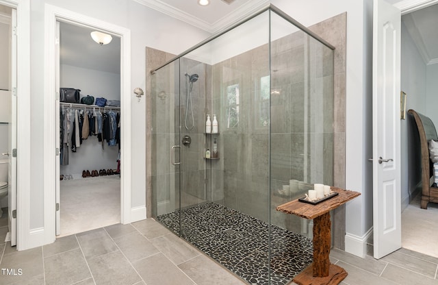 bathroom featuring a shower with door, toilet, ornamental molding, and tile patterned flooring