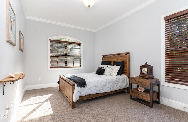 carpeted bedroom with crown molding and baseboards
