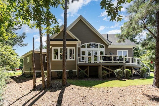 back of property featuring a lawn and a wooden deck