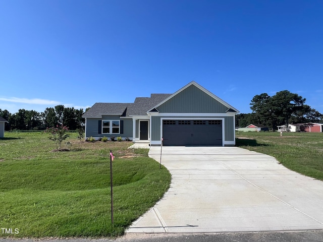 view of front of property featuring a front yard and a garage