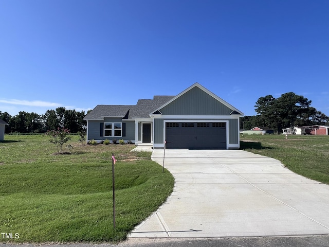 98 Lotus Ave, Smithfield, NC 27577 - view of front of property featuring a garage, roof with shingles, concrete driveway, and a front yard