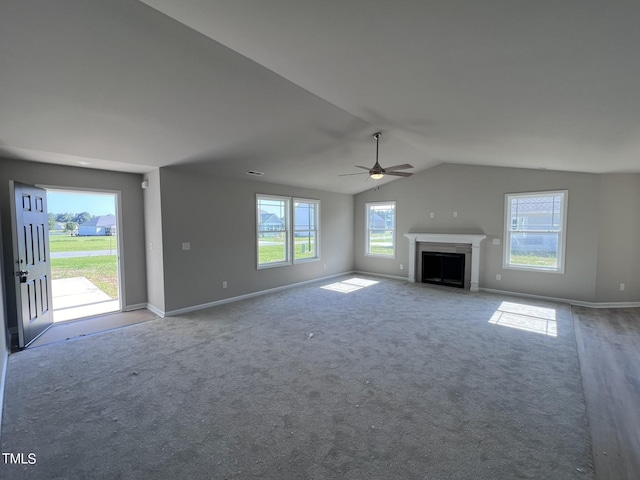 unfurnished living room with lofted ceiling, ceiling fan, and carpet flooring