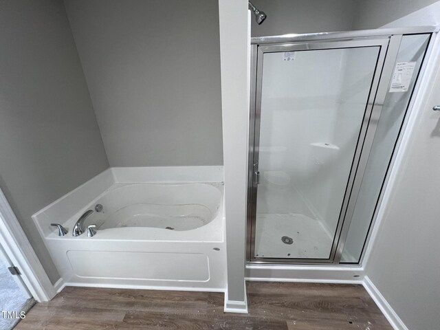 bathroom featuring separate shower and tub and wood-type flooring