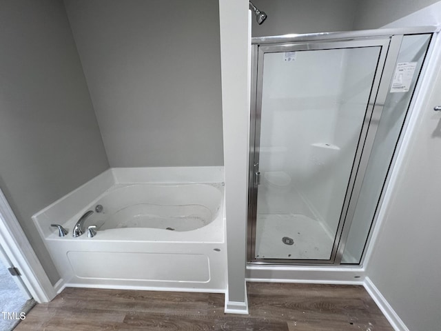 98 Lotus Ave, Smithfield, NC 27577 - bathroom with a bath, a shower stall, baseboards, and wood finished floors