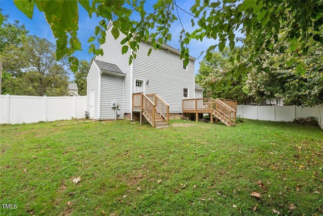 back of house with a yard and a deck