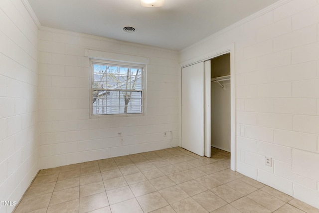 unfurnished bedroom featuring a closet and ornamental molding