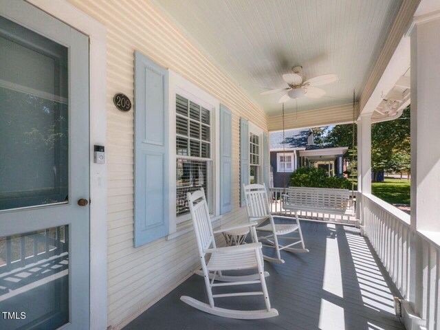 wooden deck featuring ceiling fan and a porch