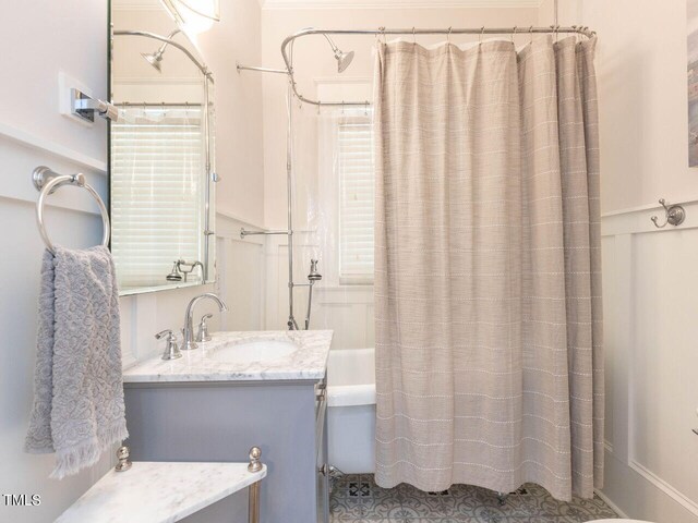 bathroom featuring vanity and shower / tub combo with curtain