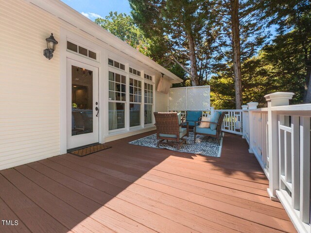 wooden terrace with an outdoor hangout area