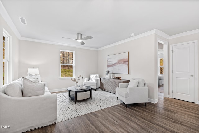 living room featuring dark hardwood / wood-style flooring, ceiling fan, and crown molding