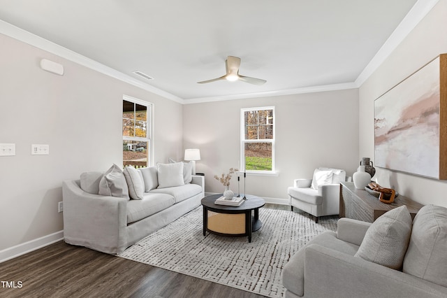 living room with dark hardwood / wood-style floors, ceiling fan, and crown molding