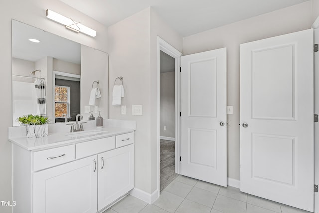 bathroom with tile patterned floors, vanity, and walk in shower