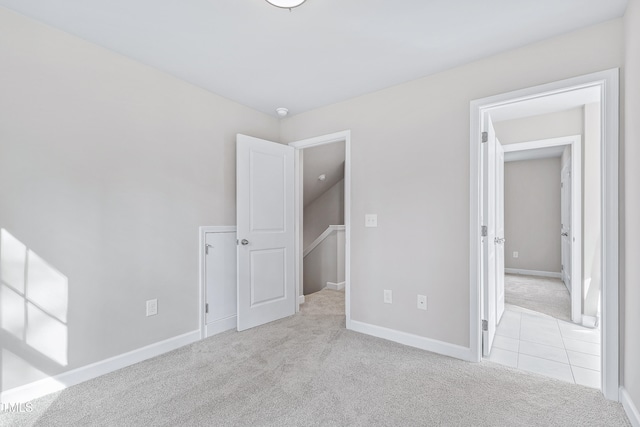 unfurnished bedroom featuring light carpet