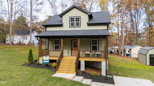 view of front of house with covered porch and a front yard