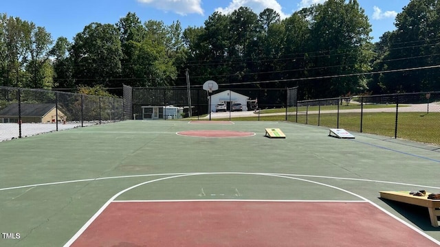 view of sport court with a yard