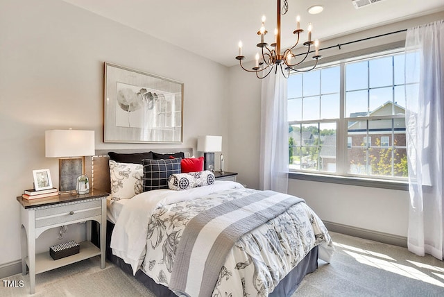 carpeted bedroom with a chandelier