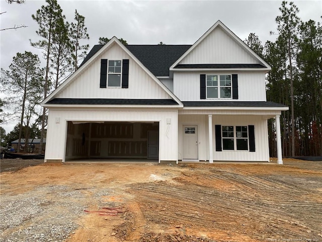 view of front of property featuring covered porch and a garage