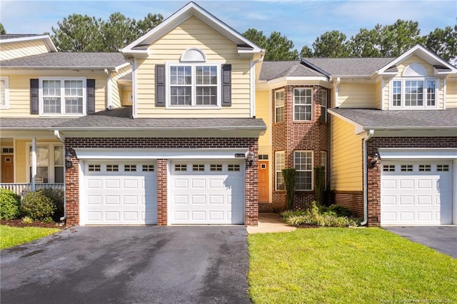 view of front of home with a garage and a front lawn