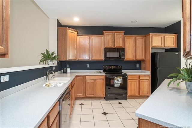 kitchen featuring black appliances, sink, and light tile patterned flooring