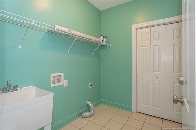 washroom featuring hookup for a washing machine, light tile patterned floors, electric dryer hookup, and sink