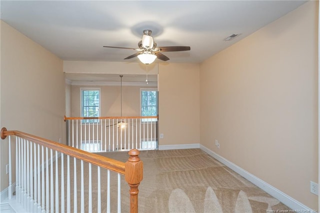 empty room with ceiling fan and light colored carpet