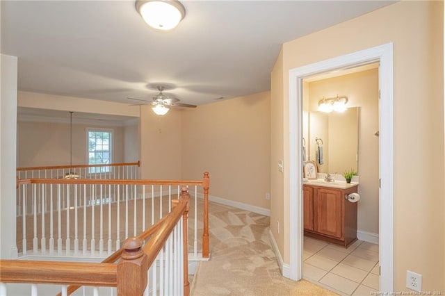 corridor featuring light colored carpet