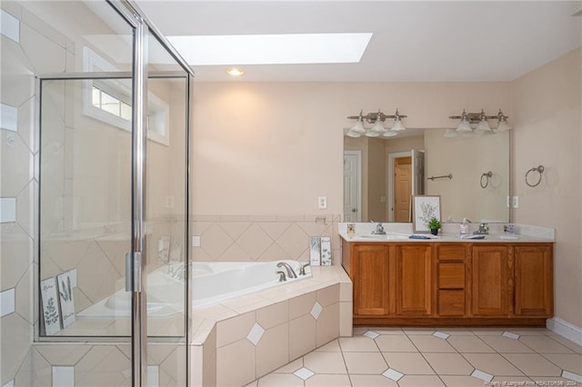 bathroom featuring a skylight, tile patterned flooring, shower with separate bathtub, and vanity