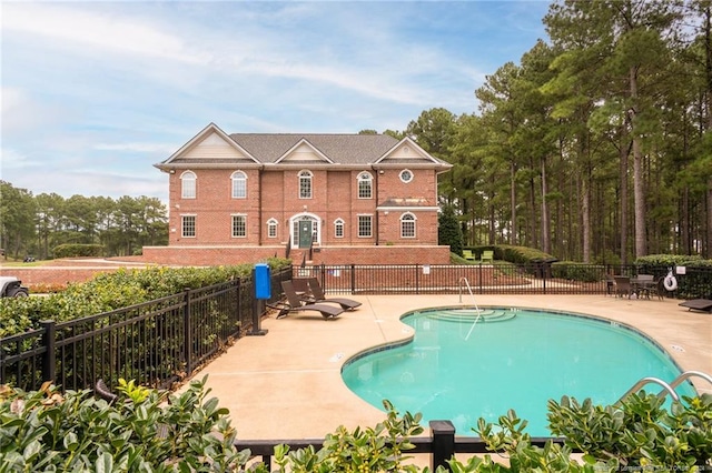 view of swimming pool with a patio