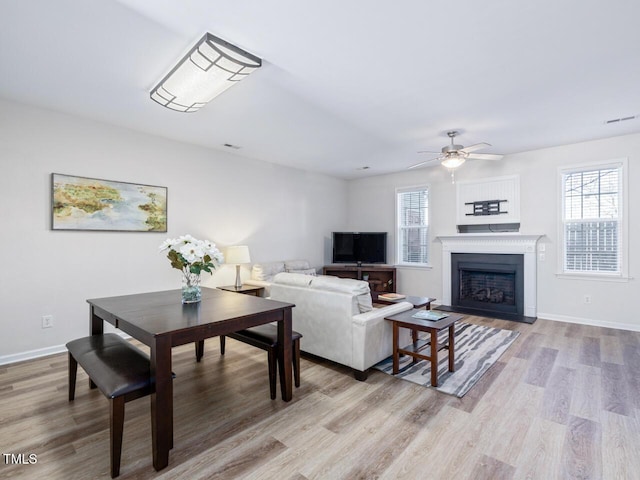 living room with light wood-type flooring and ceiling fan