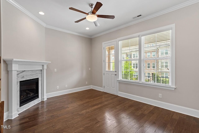 unfurnished living room with visible vents, crown molding, baseboards, ceiling fan, and hardwood / wood-style floors