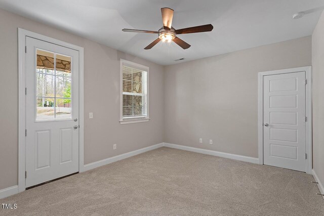 interior space featuring carpet flooring, visible vents, baseboards, and ceiling fan