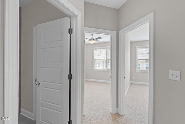 hallway with light colored carpet