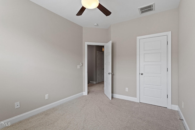 unfurnished bedroom featuring ceiling fan and light carpet