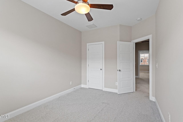 unfurnished bedroom featuring baseboards, carpet floors, ceiling fan, and visible vents