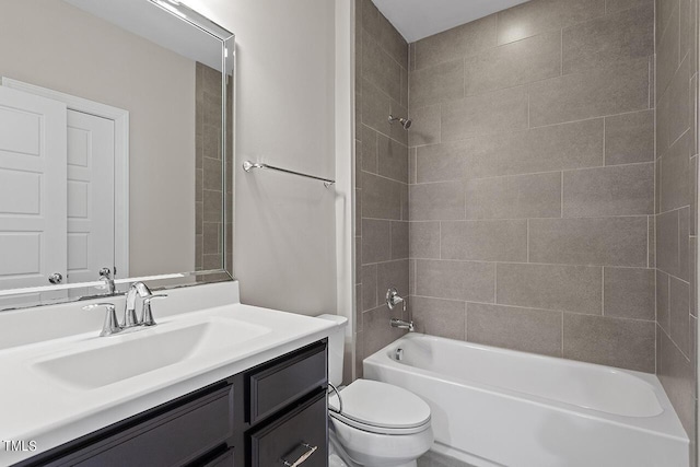 bathroom with shower / bathing tub combination, toilet, and vanity