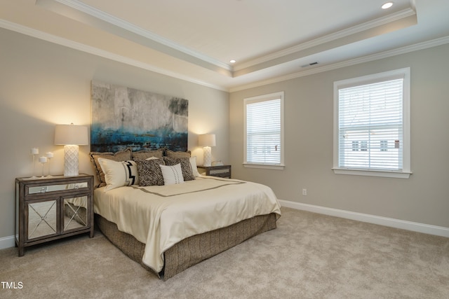 carpeted bedroom with crown molding, a tray ceiling, baseboards, and visible vents