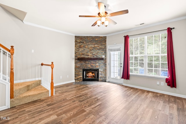 unfurnished living room with crown molding, hardwood / wood-style flooring, a fireplace, and ceiling fan