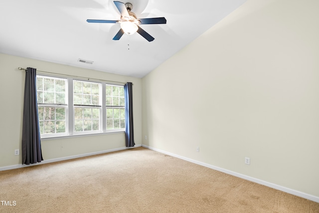 unfurnished room with ceiling fan, lofted ceiling, and carpet floors