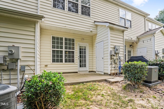 property entrance with a patio area and central AC unit