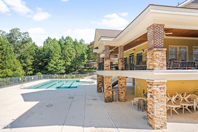 view of swimming pool featuring a patio area and an outdoor bar